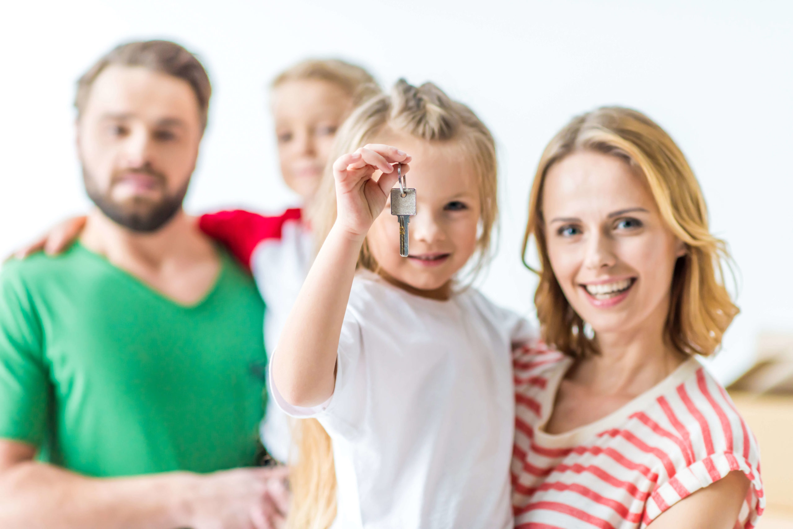 Happy Family with their daughter holding their new house key
